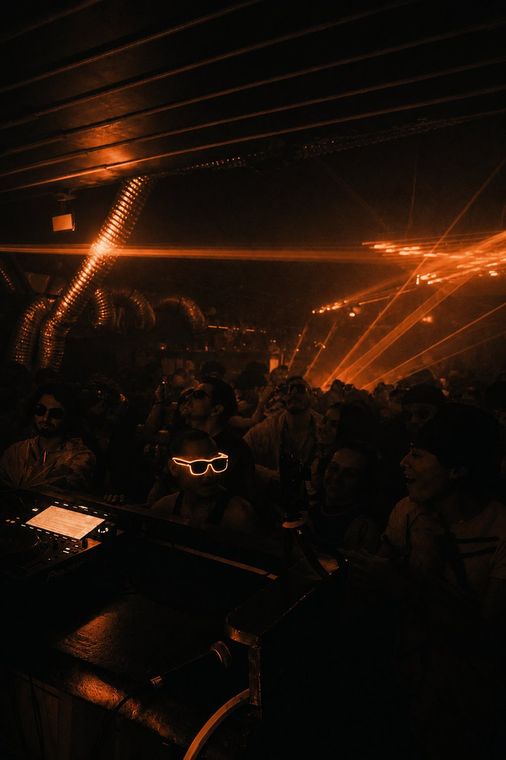 DJ working the booth under low light